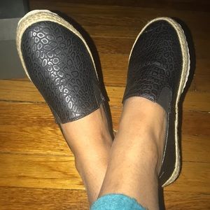 A pair of black slip on shoes